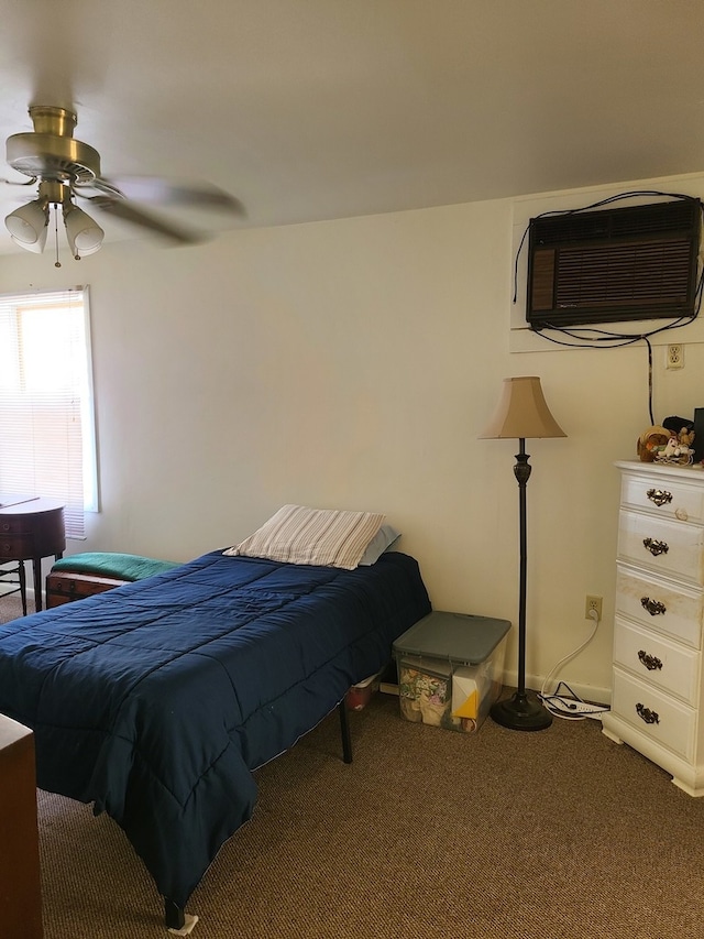 bedroom with ceiling fan, carpet, and a wall unit AC