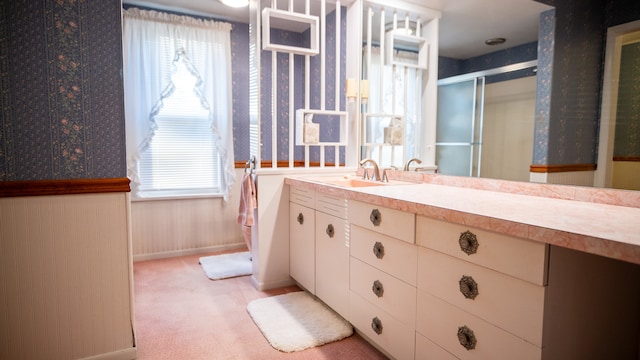 bathroom featuring vanity and an enclosed shower