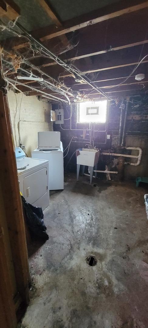 basement featuring separate washer and dryer and sink