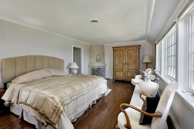 bedroom with dark hardwood / wood-style flooring and ornamental molding