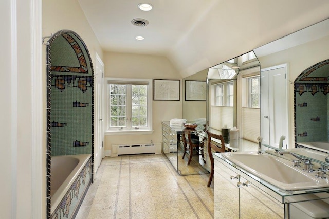 bathroom with vanity, a baseboard radiator, a bathtub, and vaulted ceiling