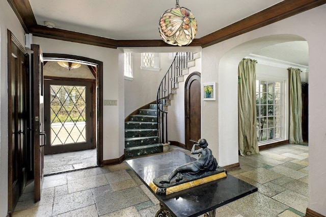 entryway featuring ornamental molding and a chandelier