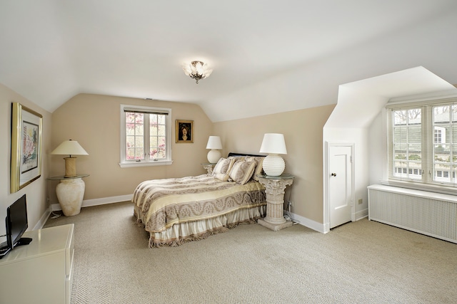 bedroom with radiator, lofted ceiling, and carpet flooring