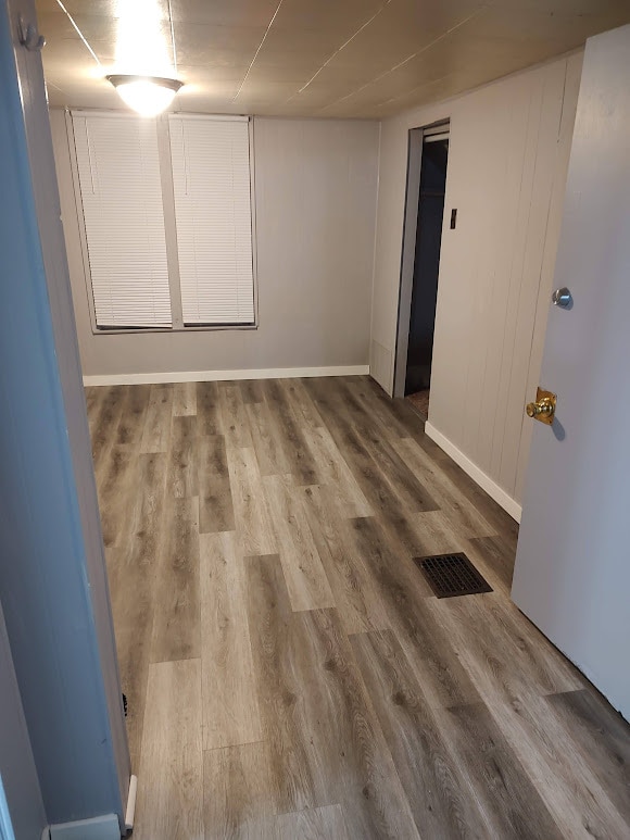 spare room with wood-type flooring