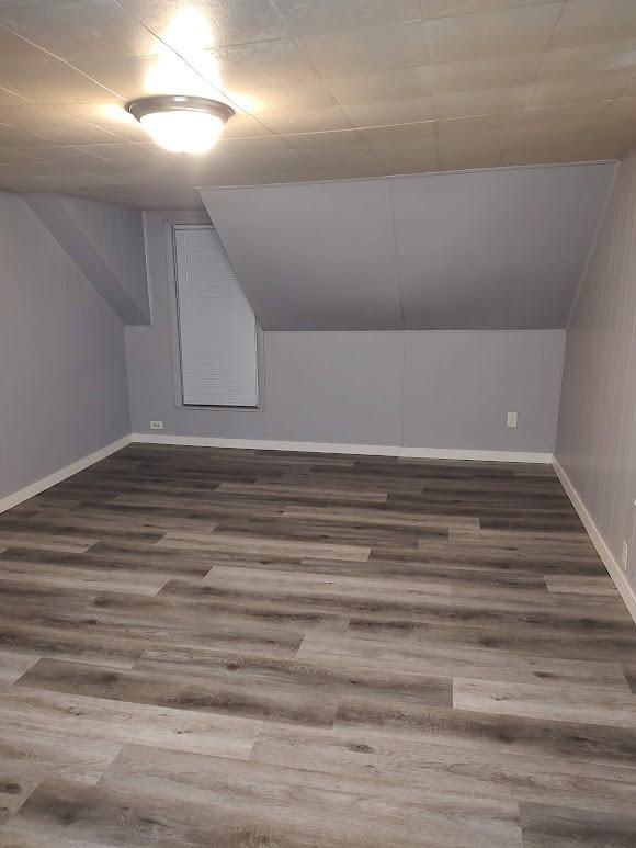 706 W Front, Bloomington, IL 61701 - additional living space featuring lofted ceiling, wood finished floors, and baseboards
