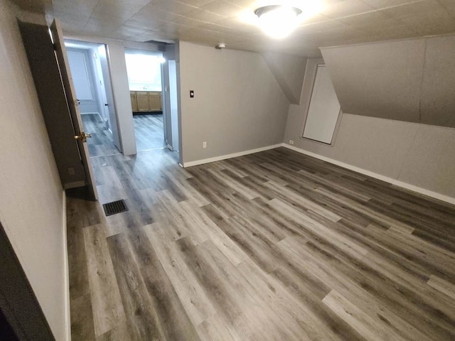 additional living space featuring hardwood / wood-style floors