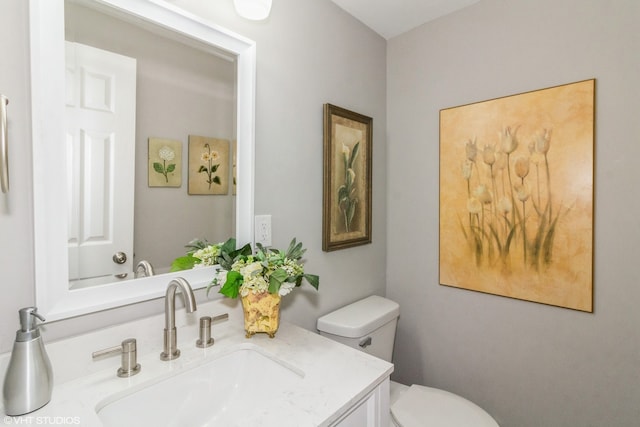 bathroom featuring toilet and vanity