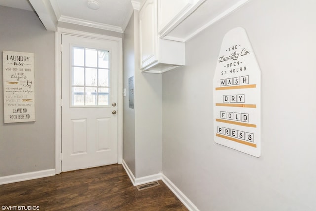 entryway with dark hardwood / wood-style floors and crown molding