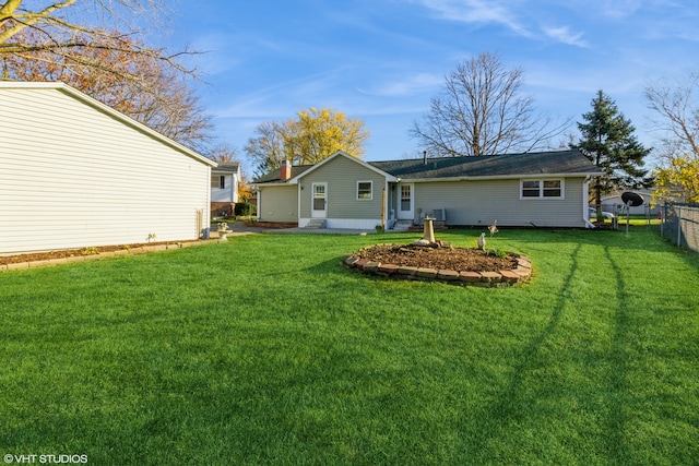 rear view of house with a lawn