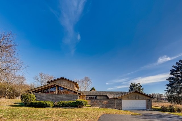 view of front of property with a front lawn and a garage