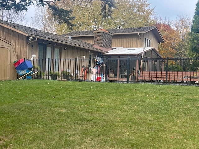 rear view of house featuring a lawn