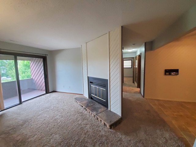 unfurnished living room featuring carpet