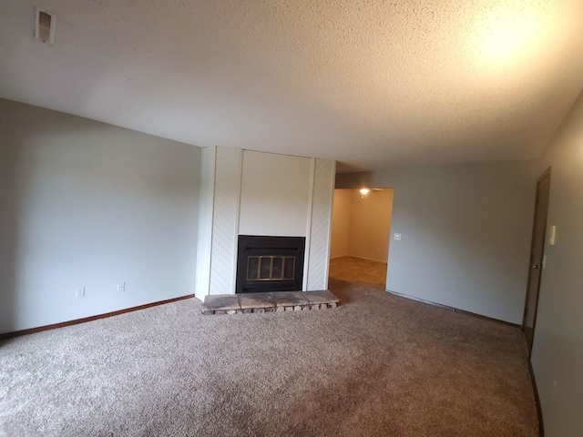 unfurnished living room featuring a textured ceiling and carpet floors