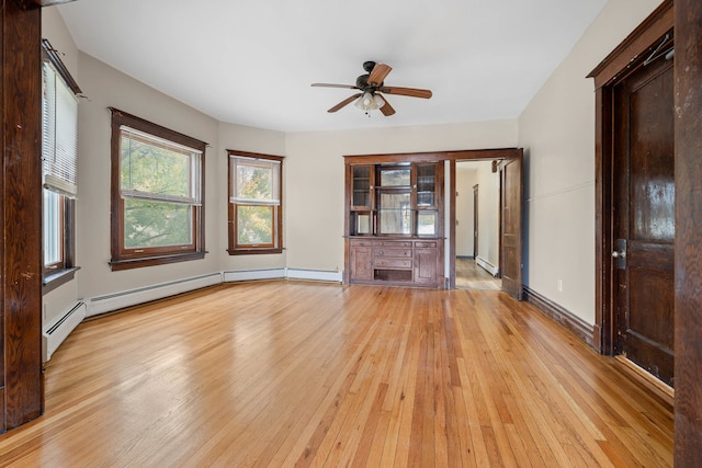 unfurnished living room featuring baseboard heating, ceiling fan, and light hardwood / wood-style flooring