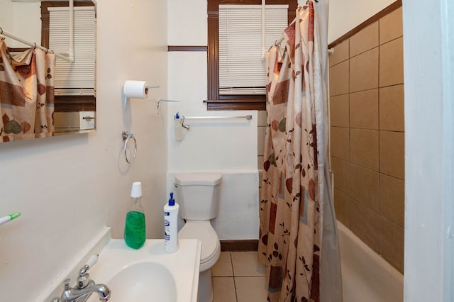 full bathroom with sink, shower / bath combo with shower curtain, toilet, and tile patterned flooring