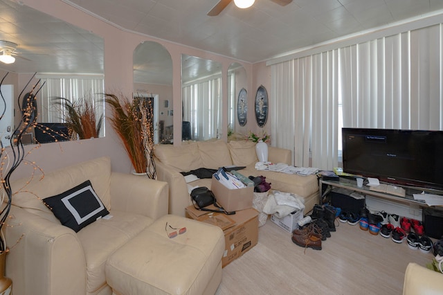 living room featuring light wood-type flooring, plenty of natural light, and ceiling fan