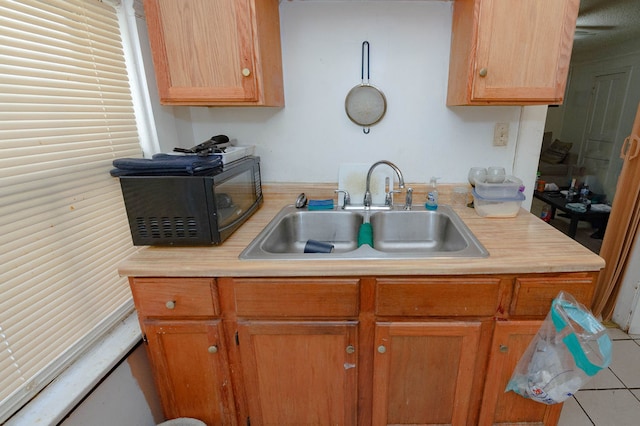 kitchen featuring tile patterned floors and sink