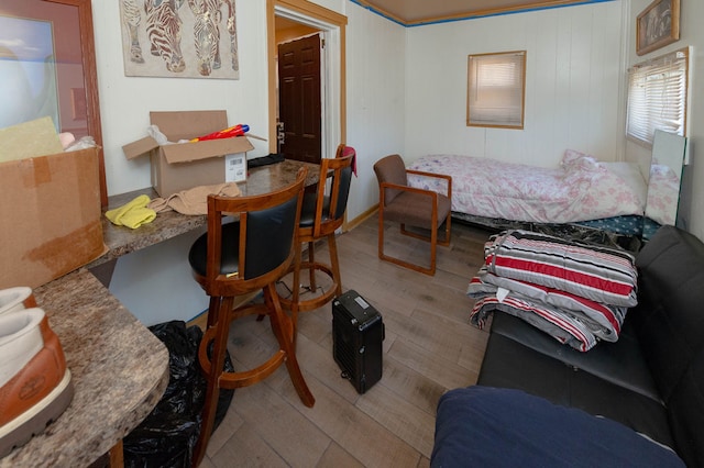 bedroom with light hardwood / wood-style floors and ornamental molding