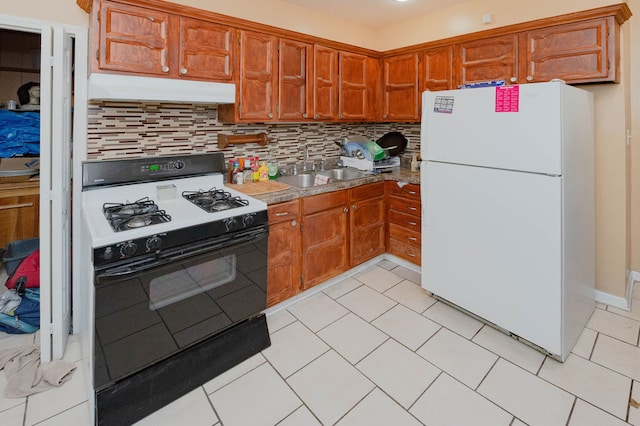 kitchen with decorative backsplash, sink, light tile patterned floors, and white appliances