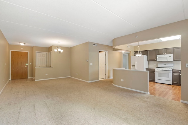 124 W Colfax St Unit 301, Palatine, IL 60067 - unfurnished living room featuring light carpet and a chandelier