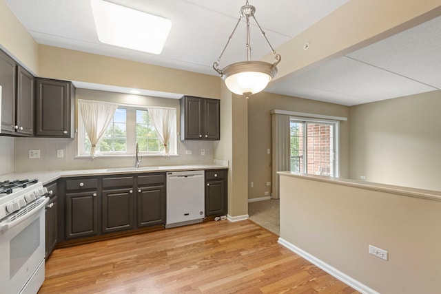 124 W Colfax St Unit 301, Palatine, IL 60067 - kitchen with white appliances, backsplash, light countertops, light wood-style flooring, and pendant lighting