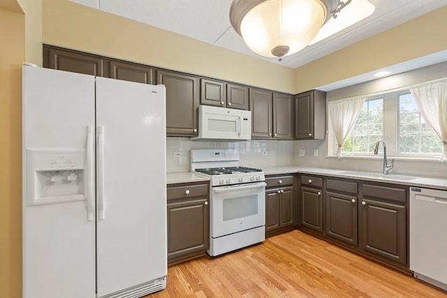 124 W Colfax St Unit 301, Palatine, IL 60067 - kitchen featuring white appliances, light countertops, backsplash, and light wood-style flooring