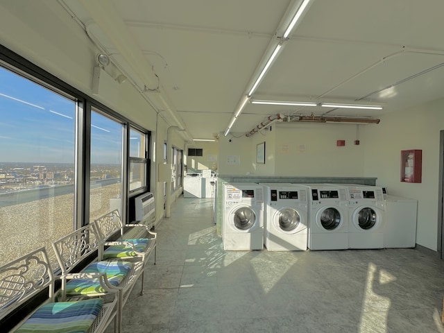 washroom featuring independent washer and dryer and a wall mounted AC