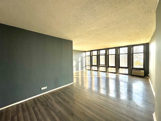 unfurnished room with a textured ceiling and dark hardwood / wood-style floors