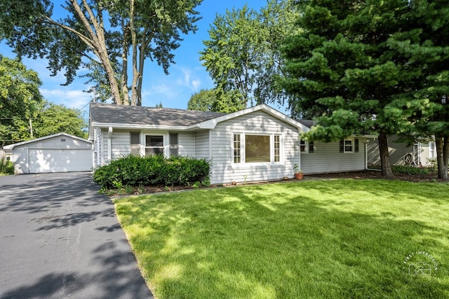 view of front of house with an outdoor structure, a front yard, and a garage