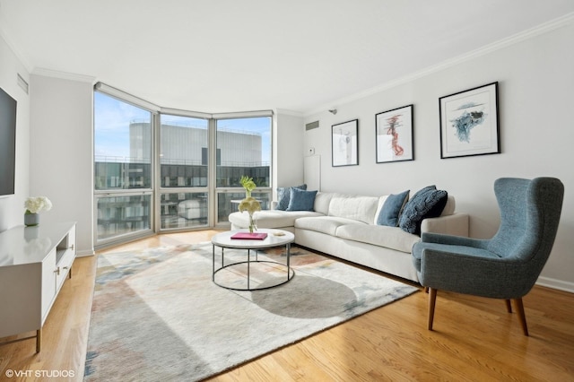 living room featuring light hardwood / wood-style flooring, floor to ceiling windows, and crown molding