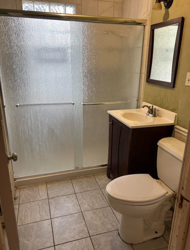 bathroom with vanity, toilet, and walk in shower