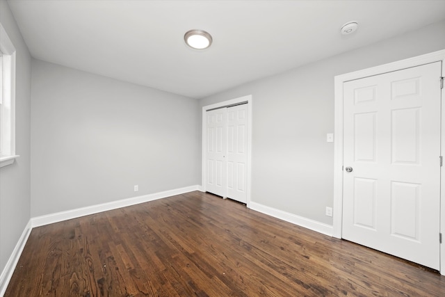 unfurnished bedroom with dark hardwood / wood-style floors