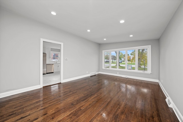 spare room with wood-type flooring