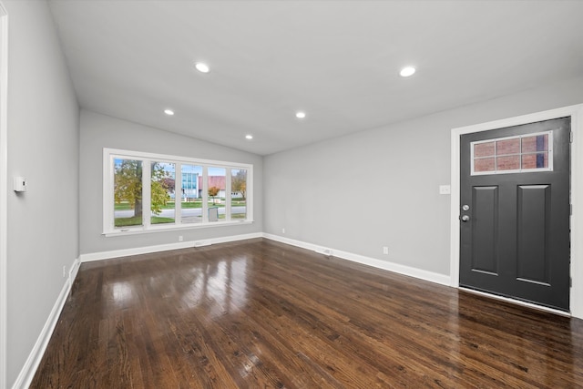 entrance foyer with dark hardwood / wood-style floors and vaulted ceiling