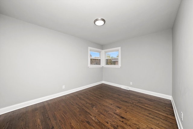 empty room with dark hardwood / wood-style floors