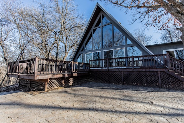 back of house featuring a wooden deck