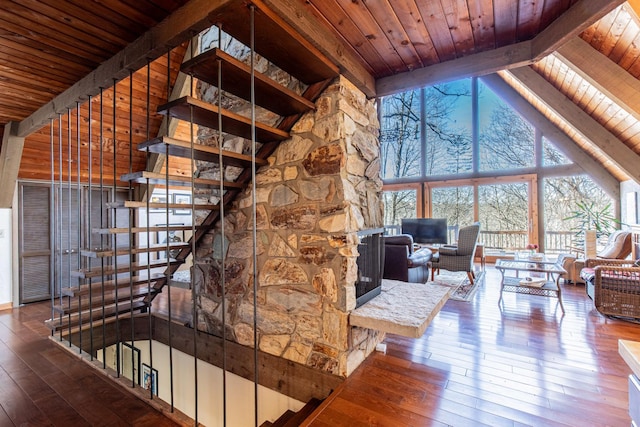 staircase with a wealth of natural light, wood ceiling, and hardwood / wood-style flooring