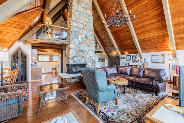 living area featuring hardwood / wood-style floors, a chandelier, and a fireplace