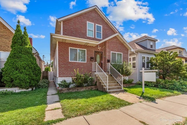 view of front of house featuring a front lawn and brick siding