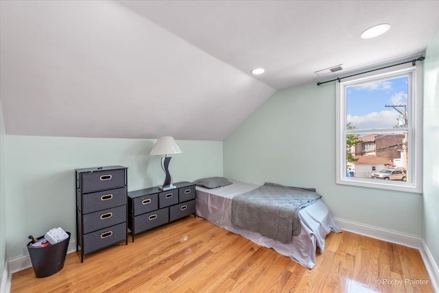 bedroom with visible vents, baseboards, recessed lighting, vaulted ceiling, and light wood-type flooring