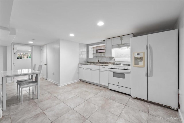 kitchen featuring under cabinet range hood, light tile patterned floors, recessed lighting, white appliances, and white cabinetry