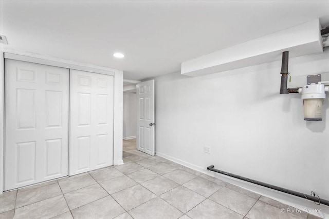 unfurnished bedroom featuring visible vents, recessed lighting, a closet, light tile patterned floors, and baseboards