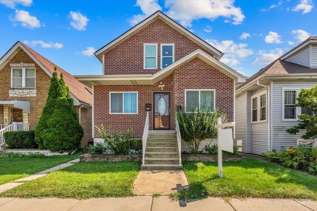 view of front of home with a front yard and brick siding