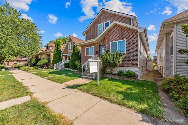 view of front of property featuring brick siding and a front lawn