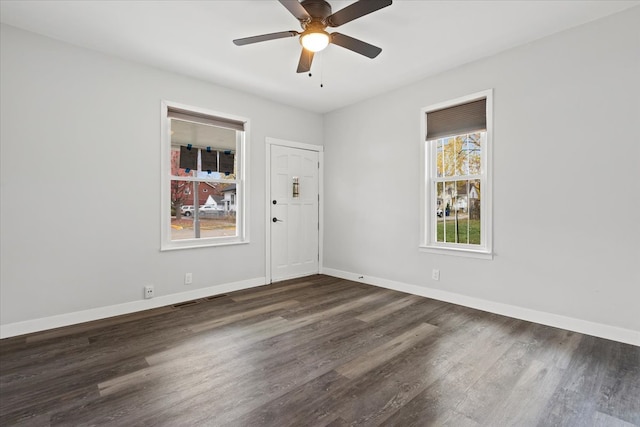 empty room featuring ceiling fan and dark hardwood / wood-style flooring