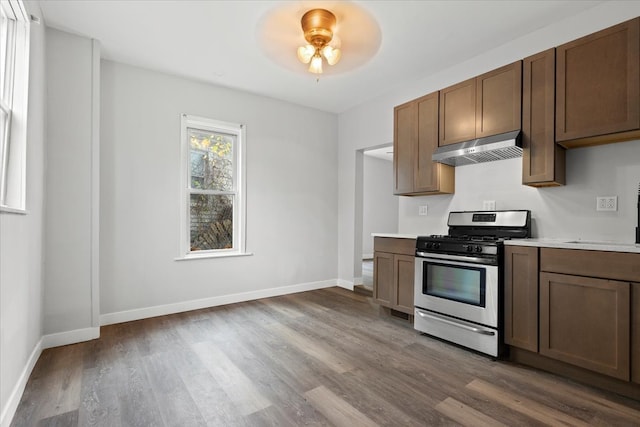 kitchen with ceiling fan, wood-type flooring, and stainless steel range with gas stovetop