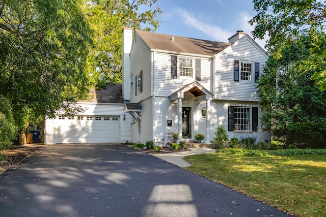 view of front of property featuring a garage and a front yard