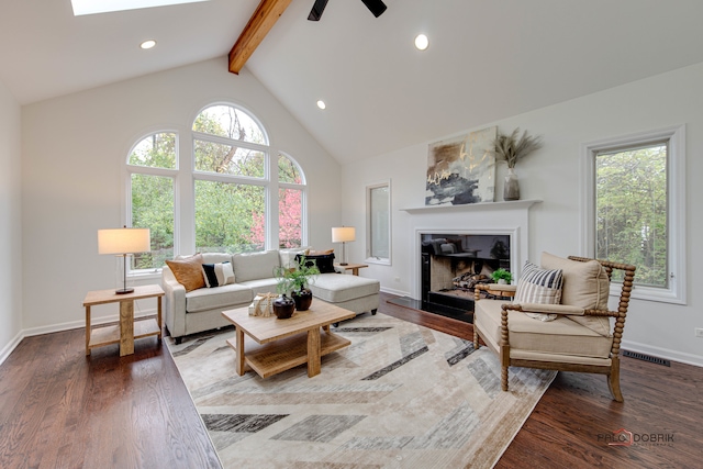 living room featuring beam ceiling, hardwood / wood-style flooring, high vaulted ceiling, and ceiling fan