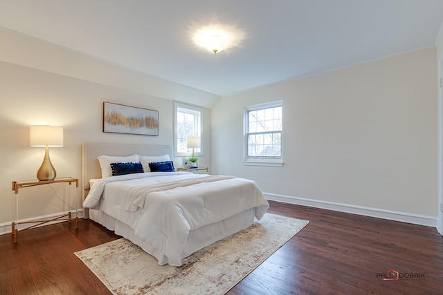 bedroom with dark hardwood / wood-style flooring