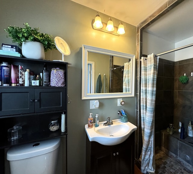 bathroom featuring vanity, toilet, and walk in shower